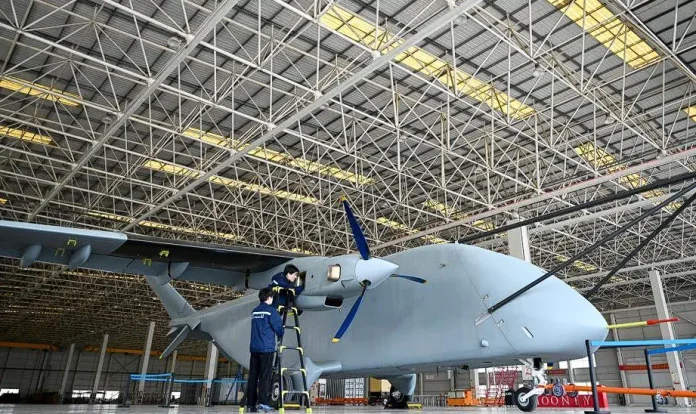Heavy cargo drone flying over extreme mountain terrain in China carrying industrial supply container